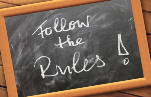 small blackboard in wooden frame with ”Follow the Rules!” written on it in chalk.